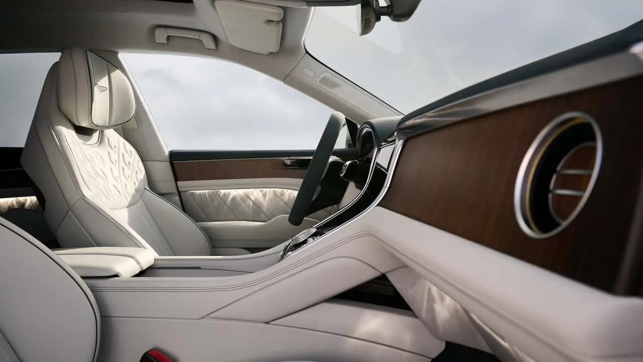Bentley Torcal EV interior showing its curved OLED display and passenger-side wood trim