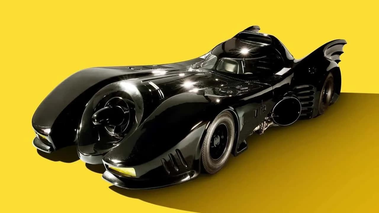 Screen-used 1992 Batman Returns Batmobile in glossy black at an auction display