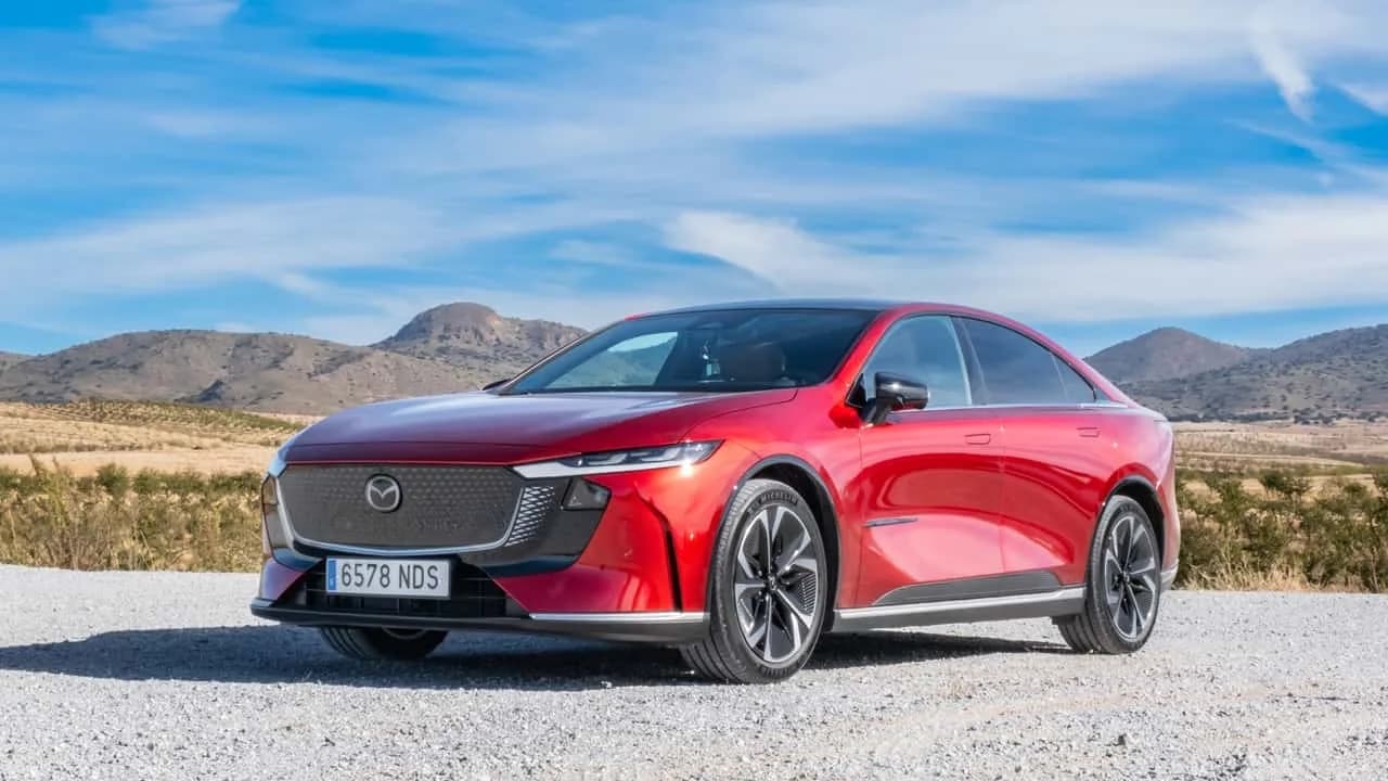 Mazda 6e electric liftback parked outdoors beside the Mazda CX-6e SUV